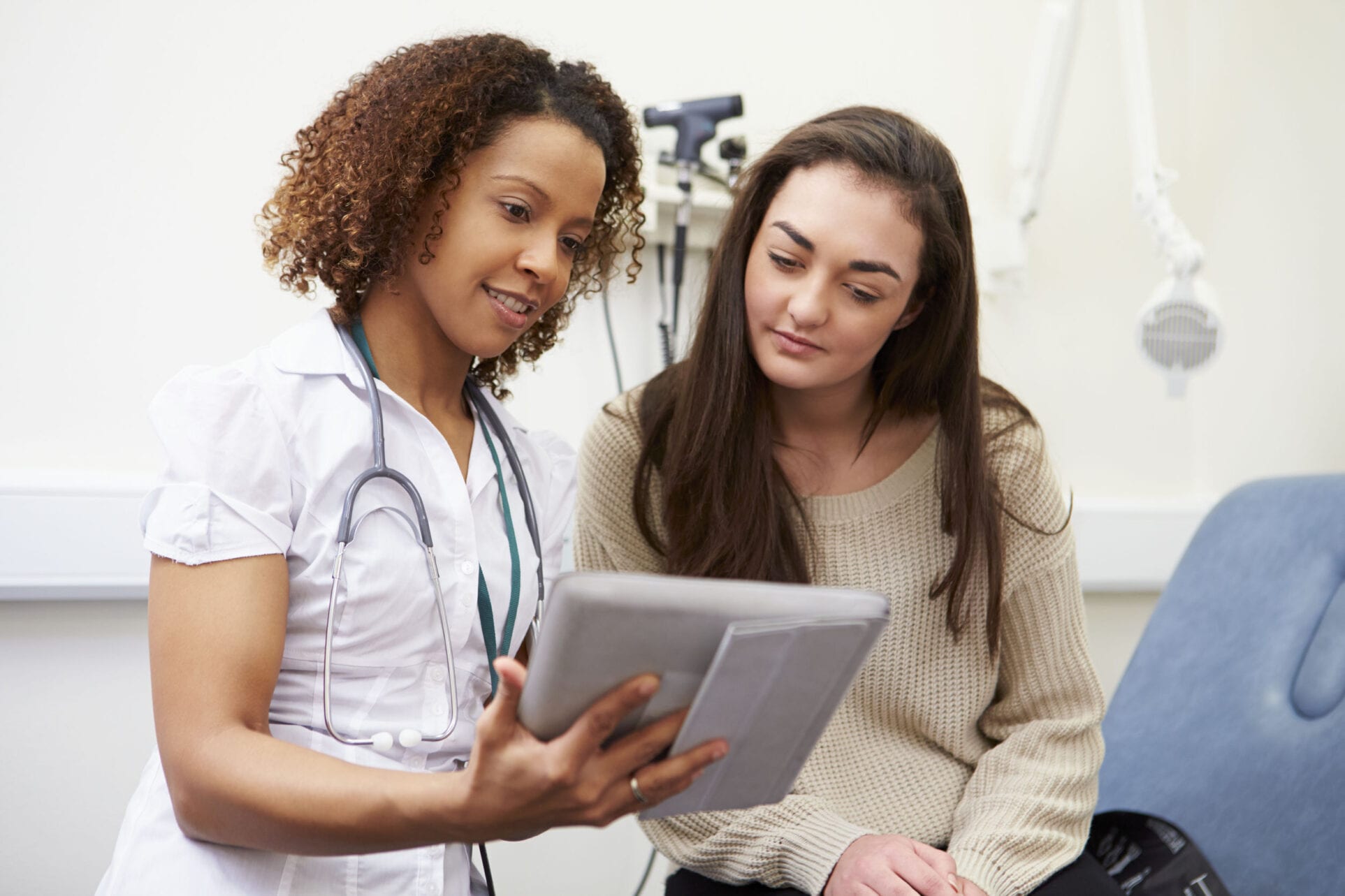 42307347 - nurse showing patient test results on digital tablet Nurse with Patient