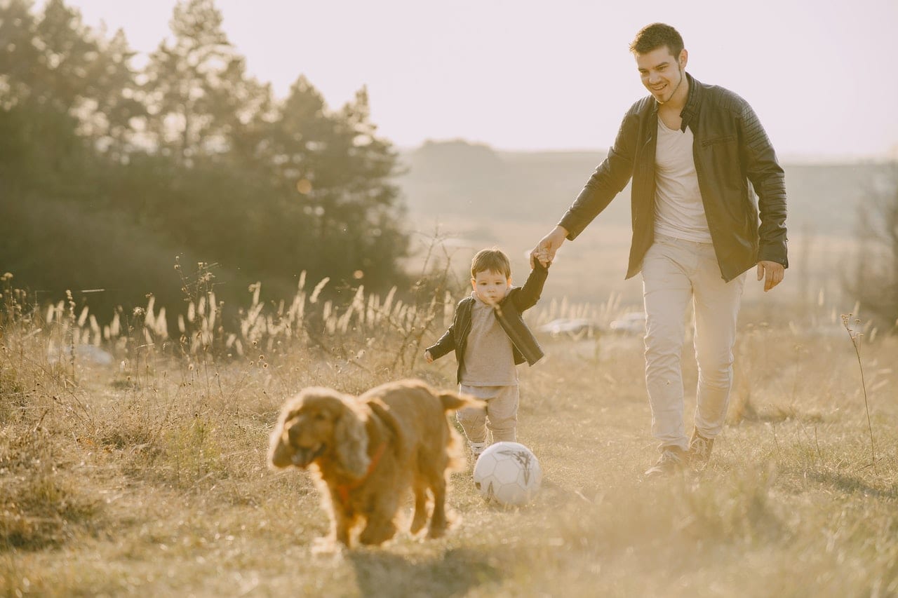 Man with child playing in garden